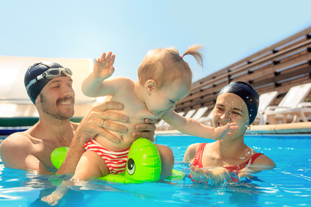 A family enjoying a swim in a well-maintained pool, emphasizing the importance of pool care and safety to prevent recreational water illnesses.